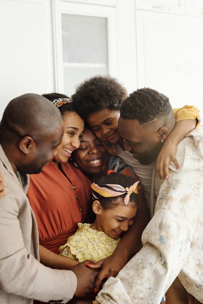 A joyful moment of family bonding captured in a warm embrace indoors.